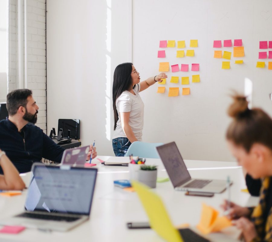 woman placing sticky notes on wall